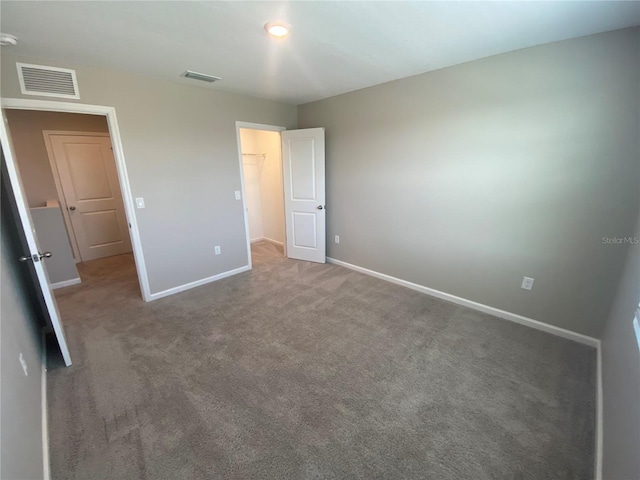 35233 White Water Lily Way, Zephyrhills, FL 33541 - unfurnished bedroom featuring carpet and a spacious closet