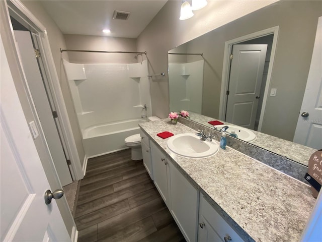 35233 White Water Lily Way, Zephyrhills, FL 33541 - bathroom featuring vanity, wood finished floors, and shower / bathtub combination