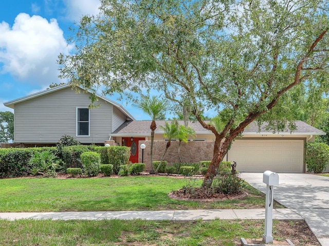 617 Valley Hill Dr, Brandon, FL 33510 - tri-level home with concrete driveway, a garage, a front yard, and a shingled roof