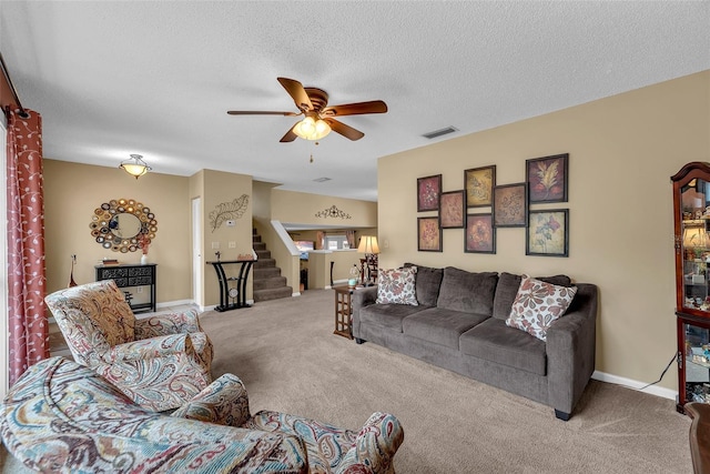 617 Valley Hill Dr, Brandon, FL 33510 - carpeted living room with ceiling fan, stairway, and a textured ceiling