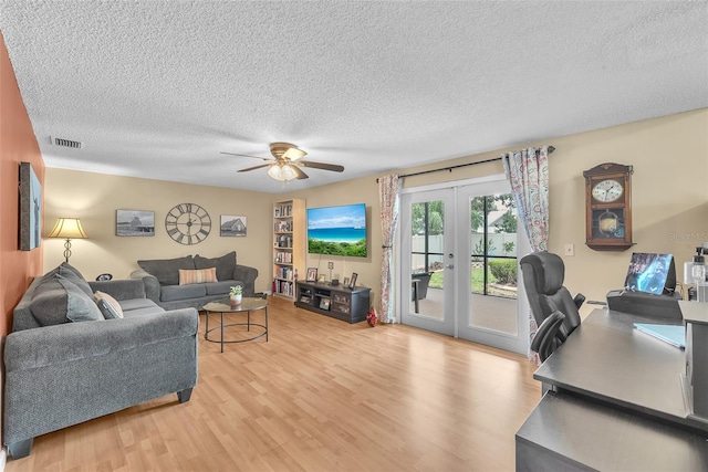 617 Valley Hill Dr, Brandon, FL 33510 - living area featuring french doors, light wood-type flooring, a textured ceiling, and a ceiling fan
