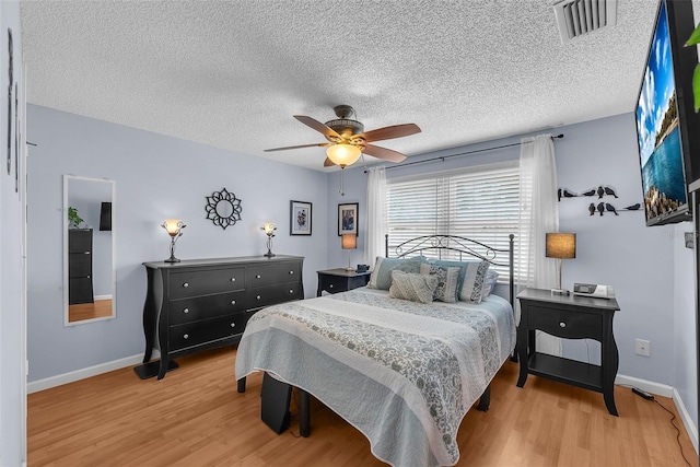 617 Valley Hill Dr, Brandon, FL 33510 - bedroom featuring light wood-style floors, a textured ceiling, and a ceiling fan