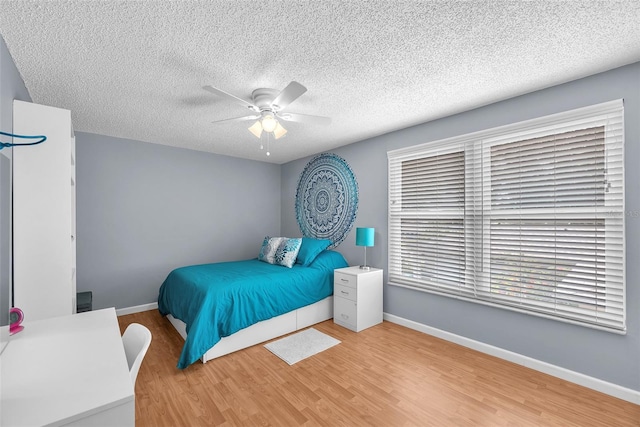 617 Valley Hill Dr, Brandon, FL 33510 - bedroom featuring wood finished floors, a textured ceiling, and a ceiling fan