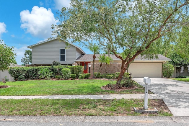 617 Valley Hill Dr, Brandon, FL 33510 - tri-level home featuring driveway, a garage, and a front yard
