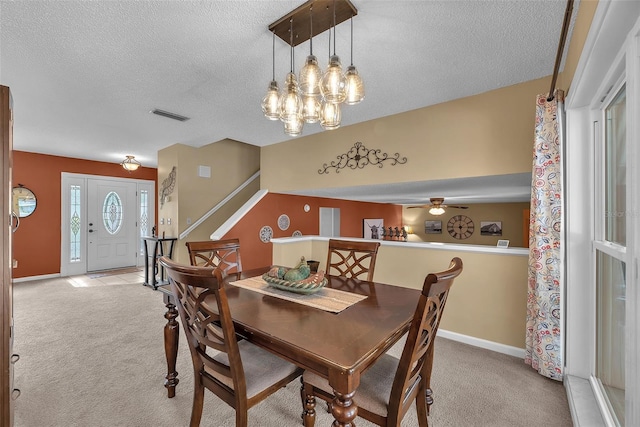 617 Valley Hill Dr, Brandon, FL 33510 - dining space with light carpet, a textured ceiling, a chandelier, stairway, and a ceiling fan