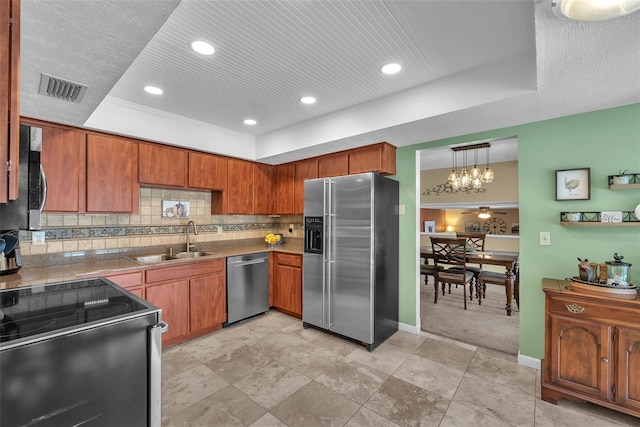 617 Valley Hill Dr, Brandon, FL 33510 - kitchen featuring appliances with stainless steel finishes, a raised ceiling, a chandelier, decorative backsplash, and brown cabinets