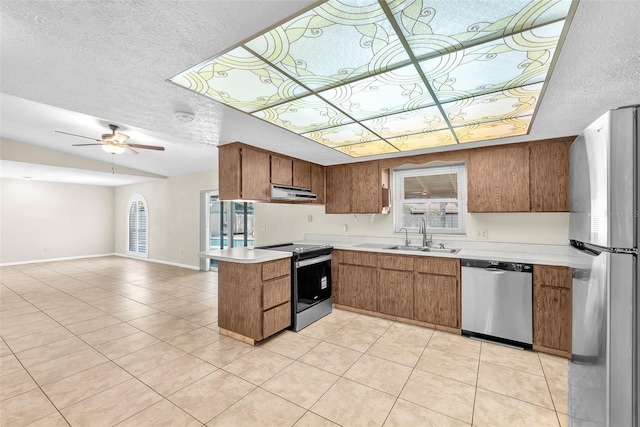 3840 Rolling Cir, Valrico, FL 33594 - kitchen with appliances with stainless steel finishes, exhaust hood, a textured ceiling, brown cabinets, and light countertops