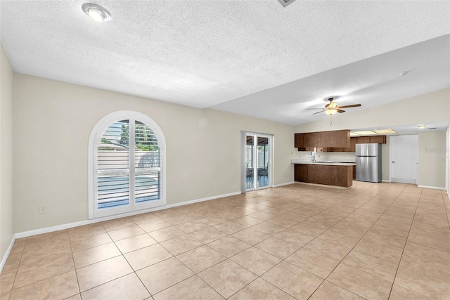 3840 Rolling Cir, Valrico, FL 33594 - unfurnished living room featuring light tile patterned floors, a textured ceiling, and a ceiling fan