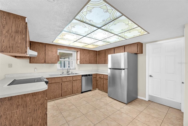 3840 Rolling Cir, Valrico, FL 33594 - kitchen with appliances with stainless steel finishes, a textured ceiling, light countertops, brown cabinets, and exhaust hood