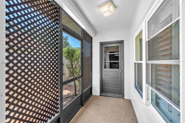 3840 Rolling Cir, Valrico, FL 33594 - doorway to outside featuring a textured ceiling and carpet