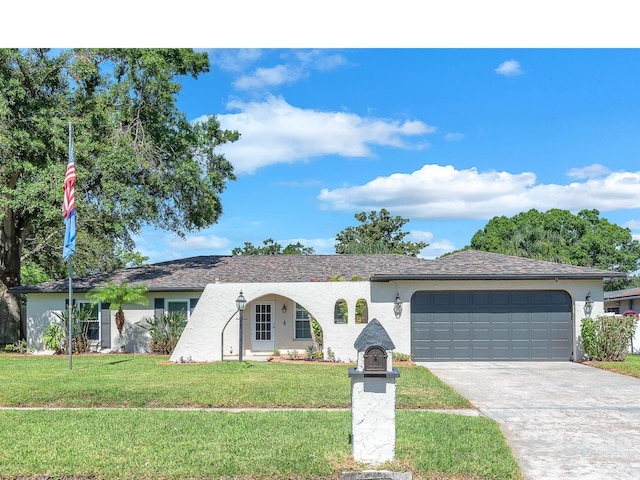 3840 Rolling Cir, Valrico, FL 33594 - ranch-style home featuring stucco siding, concrete driveway, a garage, and a front yard