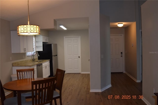 3600 Raintree Ter, Lakeland, FL 33803 - dining area with wood finished floors and lofted ceiling