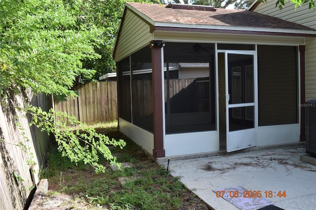 3600 Raintree Ter, Lakeland, FL 33803 - view of home's exterior featuring a sunroom, roof with shingles, and a patio area