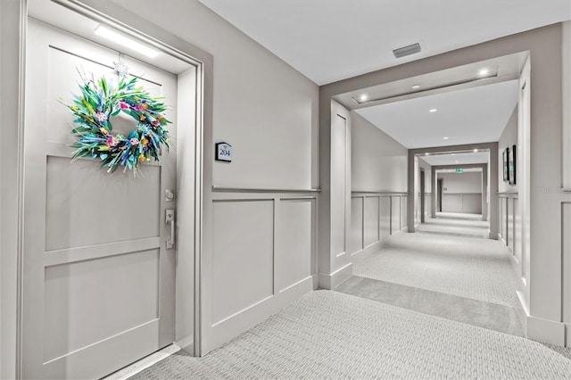 200 Main St Unit 204, Dunedin, FL 34698 - corridor with carpet floors, a decorative wall, recessed lighting, and a wainscoted wall