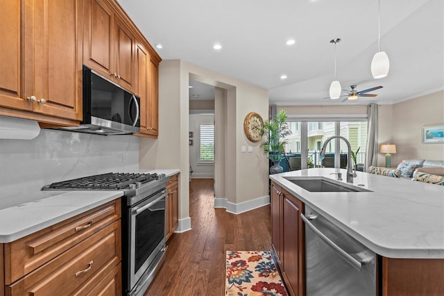 200 Main St Unit 204, Dunedin, FL 34698 - kitchen featuring appliances with stainless steel finishes, brown cabinetry, dark wood-type flooring, plenty of natural light, and recessed lighting