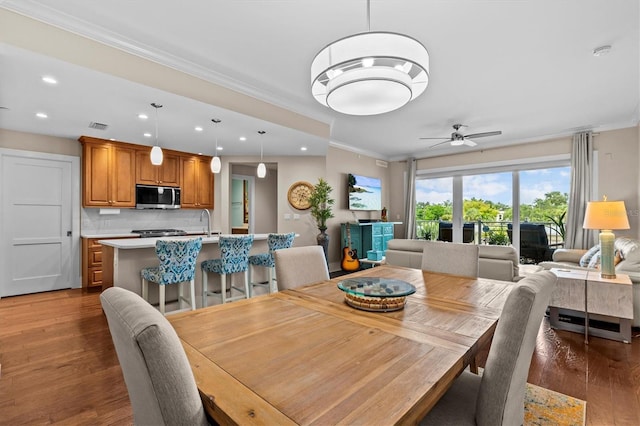 200 Main St Unit 204, Dunedin, FL 34698 - dining room with crown molding, recessed lighting, wood finished floors, and ceiling fan