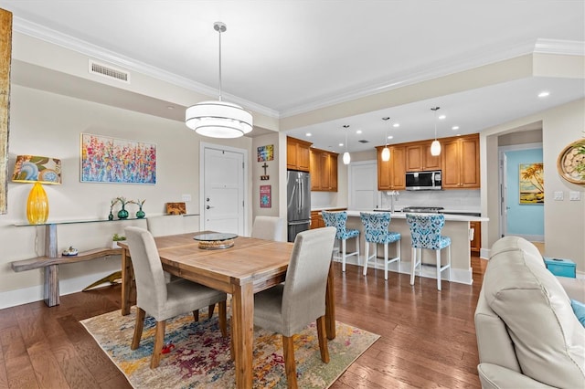 200 Main St Unit 204, Dunedin, FL 34698 - dining space with recessed lighting, ornamental molding, and dark wood-style flooring