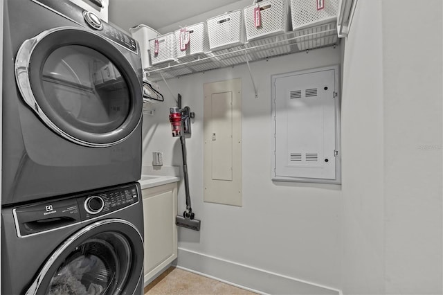 200 Main St Unit 204, Dunedin, FL 34698 - laundry room with stacked washer and clothes dryer, electric panel, and cabinet space