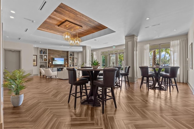 200 Main St Unit 204, Dunedin, FL 34698 - dining area with a raised ceiling, ornate columns, a chandelier, and recessed lighting