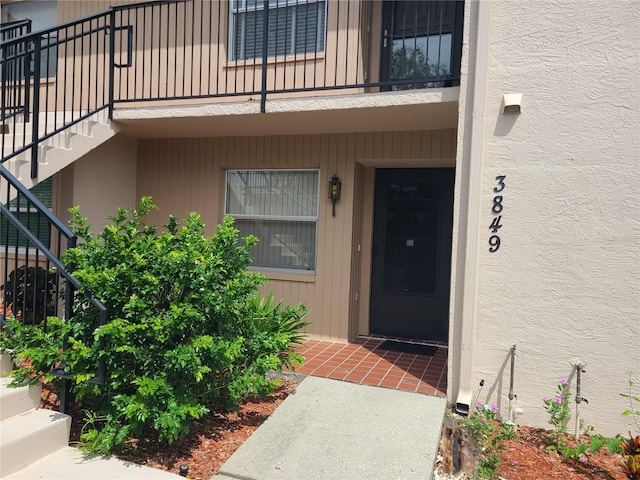 3849 Sailmaker Ln Unit 0, Holiday, FL 34691 - doorway to property with stucco siding and a balcony