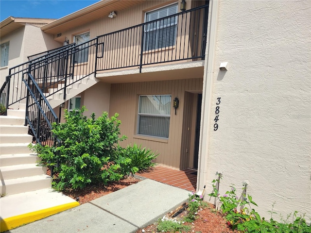 3849 Sailmaker Ln Unit 0, Holiday, FL 34691 - entrance to property featuring stucco siding and a balcony