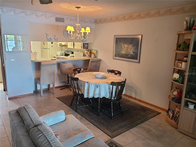 3849 Sailmaker Ln Unit 0, Holiday, FL 34691 - tiled dining area featuring a chandelier and a textured ceiling