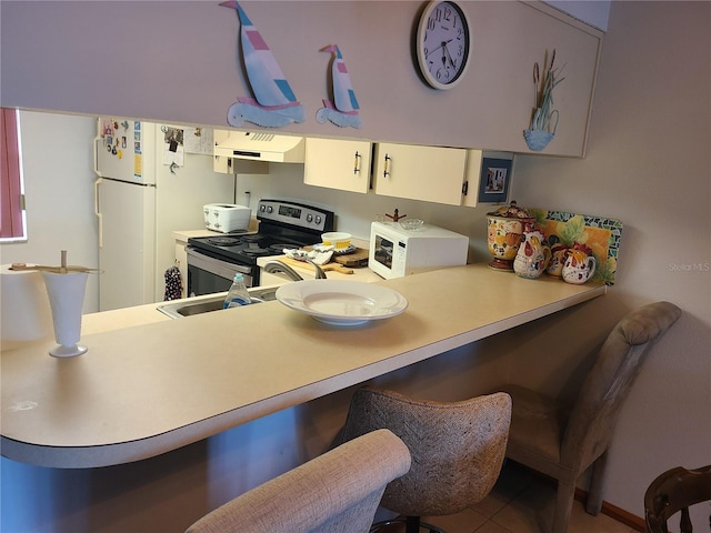 3849 Sailmaker Ln Unit 0, Holiday, FL 34691 - kitchen with white microwave, premium range hood, stainless steel electric stove, a breakfast bar, and light countertops