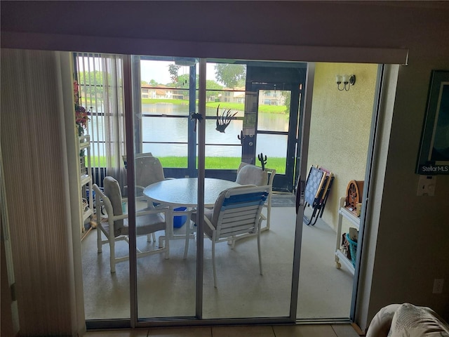 3849 Sailmaker Ln Unit 0, Holiday, FL 34691 - dining space with a water view, a textured wall, and french doors