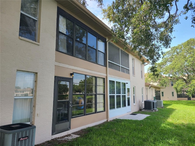 3849 Sailmaker Ln Unit 0, Holiday, FL 34691 - back of house with stucco siding and a lawn