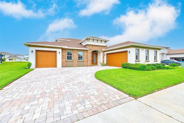 8717 Sanders Tree Loop, Wesley Chapel, FL 33545 - prairie-style house featuring an attached garage, decorative driveway, a front yard, and stucco siding