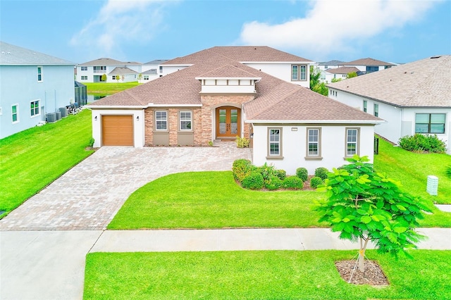 8717 Sanders Tree Loop, Wesley Chapel, FL 33545 - view of front of house featuring french doors, decorative driveway, a shingled roof, and a residential view