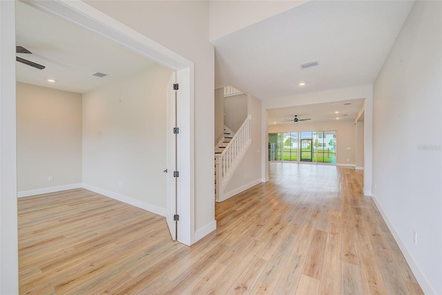 8717 Sanders Tree Loop, Wesley Chapel, FL 33545 - hallway with light wood finished floors, stairs, and recessed lighting