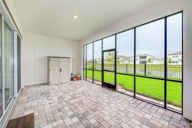 8717 Sanders Tree Loop, Wesley Chapel, FL 33545 - unfurnished sunroom featuring a water view and a residential view