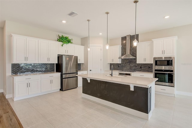 8717 Sanders Tree Loop, Wesley Chapel, FL 33545 - kitchen featuring appliances with stainless steel finishes, wall chimney range hood, backsplash, light countertops, and recessed lighting