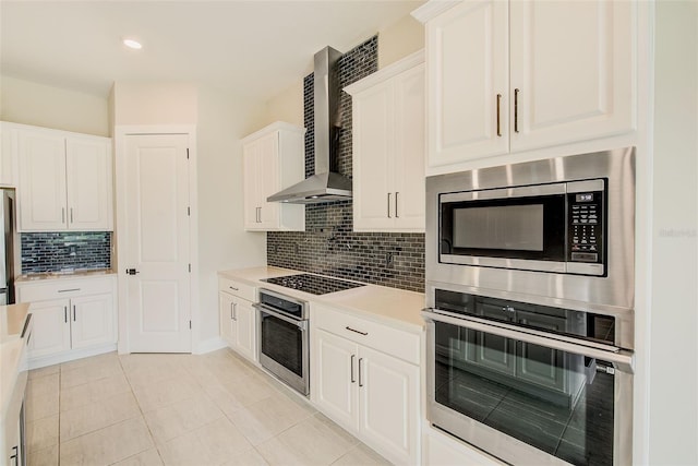 8717 Sanders Tree Loop, Wesley Chapel, FL 33545 - kitchen featuring appliances with stainless steel finishes, wall chimney range hood, decorative backsplash, light countertops, and white cabinets