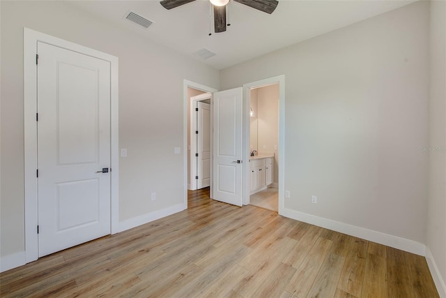 8717 Sanders Tree Loop, Wesley Chapel, FL 33545 - unfurnished bedroom featuring light wood-style floors, connected bathroom, and a ceiling fan