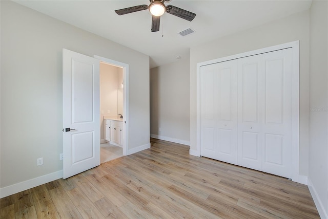 8717 Sanders Tree Loop, Wesley Chapel, FL 33545 - unfurnished bedroom with light wood-style flooring, a closet, ceiling fan, and ensuite bath