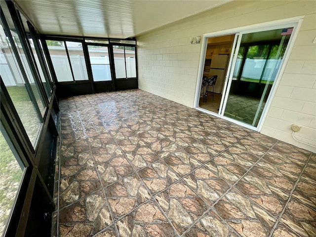 7026 20th St N, Saint Petersburg, FL 33702 - unfurnished sunroom with stone finish floors