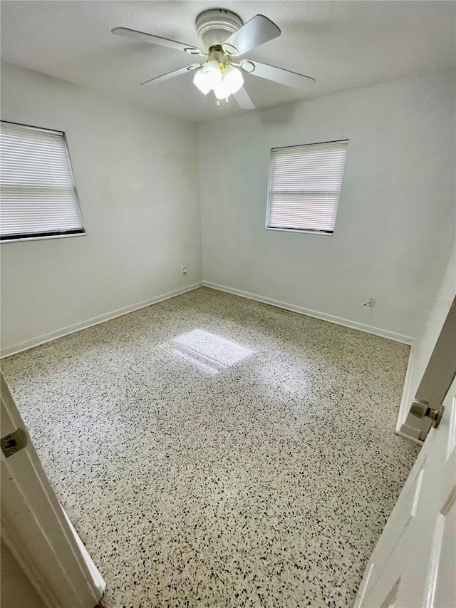 7026 20th St N, Saint Petersburg, FL 33702 - unfurnished room with speckled floor, a ceiling fan, and healthy amount of natural light