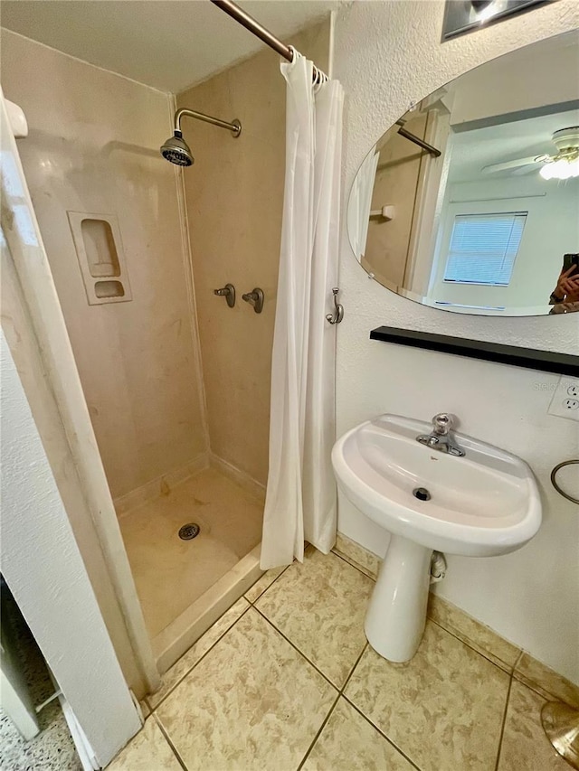7026 20th St N, Saint Petersburg, FL 33702 - bathroom featuring a shower stall, tile patterned flooring, and a ceiling fan