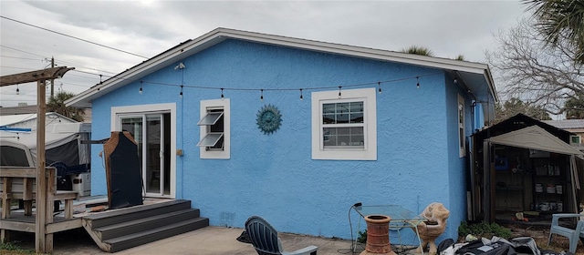 7623 Gulf Blvd, St Pete Beach, FL 33706 - back of house with entry steps and stucco siding