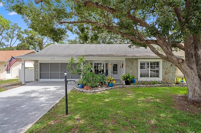 6195 Ocean Pines Ln, Spring Hill, FL 34606 - ranch-style house with stone siding, an attached garage, a front yard, and concrete driveway