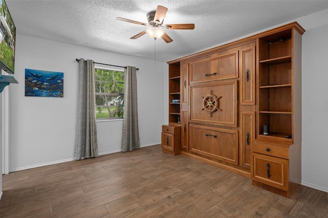 6195 Ocean Pines Ln, Spring Hill, FL 34606 - unfurnished living room featuring a ceiling fan, a textured ceiling, and wood finished floors