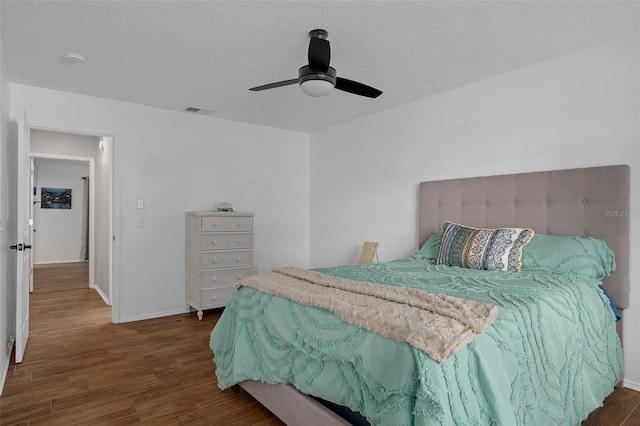 6195 Ocean Pines Ln, Spring Hill, FL 34606 - bedroom featuring wood finished floors, a ceiling fan, and a textured ceiling