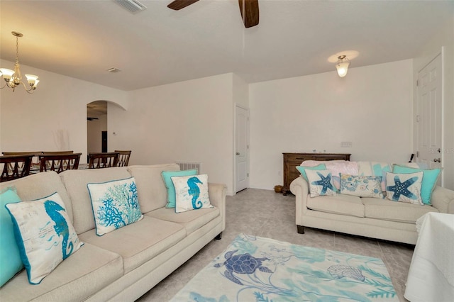 11240 Merganser Way, New Port Richey, FL 34654 - tiled living room featuring arched walkways, a ceiling fan, and a chandelier