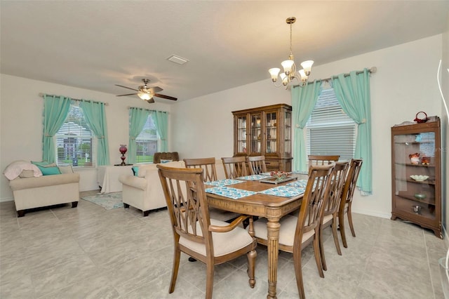 11240 Merganser Way, New Port Richey, FL 34654 - dining space featuring a chandelier, a ceiling fan, and light tile patterned flooring