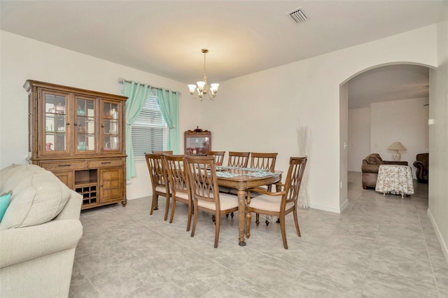 11240 Merganser Way, New Port Richey, FL 34654 - dining room featuring arched walkways and a chandelier