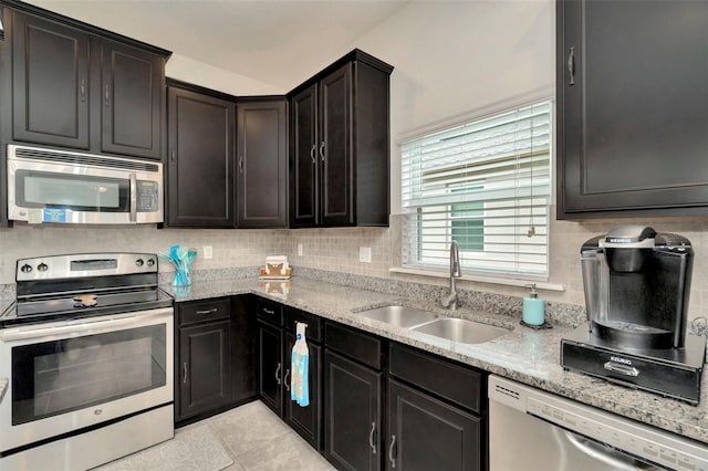 11240 Merganser Way, New Port Richey, FL 34654 - kitchen featuring stainless steel appliances, decorative backsplash, and light stone countertops