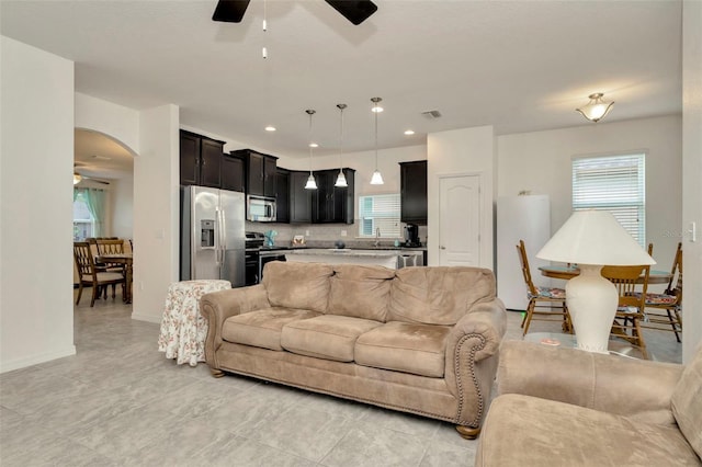 11240 Merganser Way, New Port Richey, FL 34654 - living room featuring ceiling fan, healthy amount of natural light, arched walkways, and recessed lighting