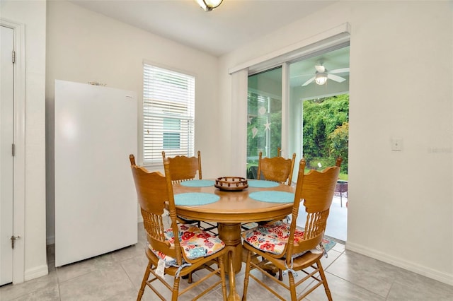 11240 Merganser Way, New Port Richey, FL 34654 - dining space featuring healthy amount of natural light, light tile patterned floors, and ceiling fan